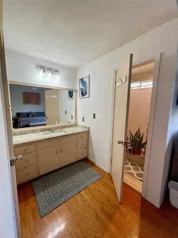 a bathroom with a double vanity sink and mirror