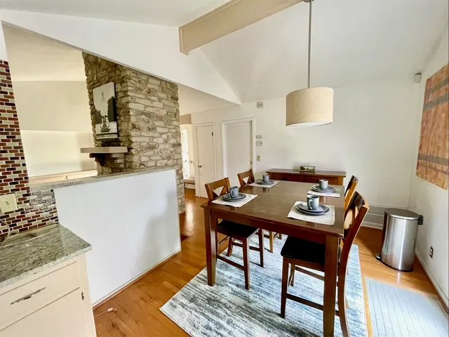 a view of a kitchen area with furniture and wooden floor