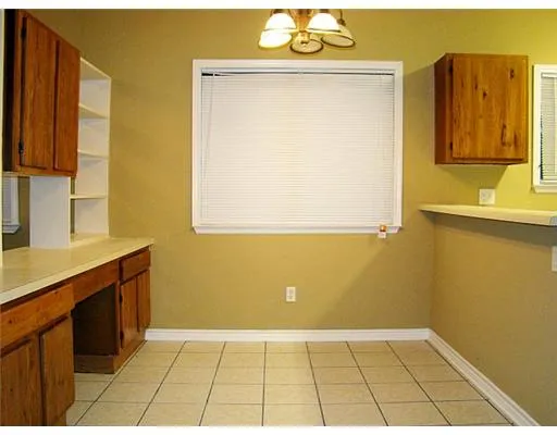 a view of a kitchen with wooden floor and a sink