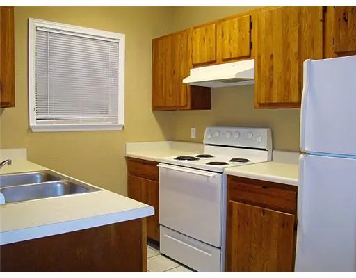 a kitchen with stainless steel appliances a stove a sink and a refrigerator