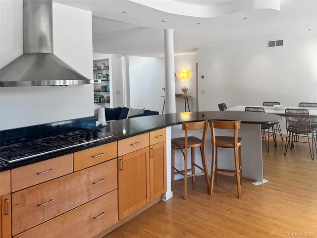 a kitchen with granite countertop a sink stove and cabinets