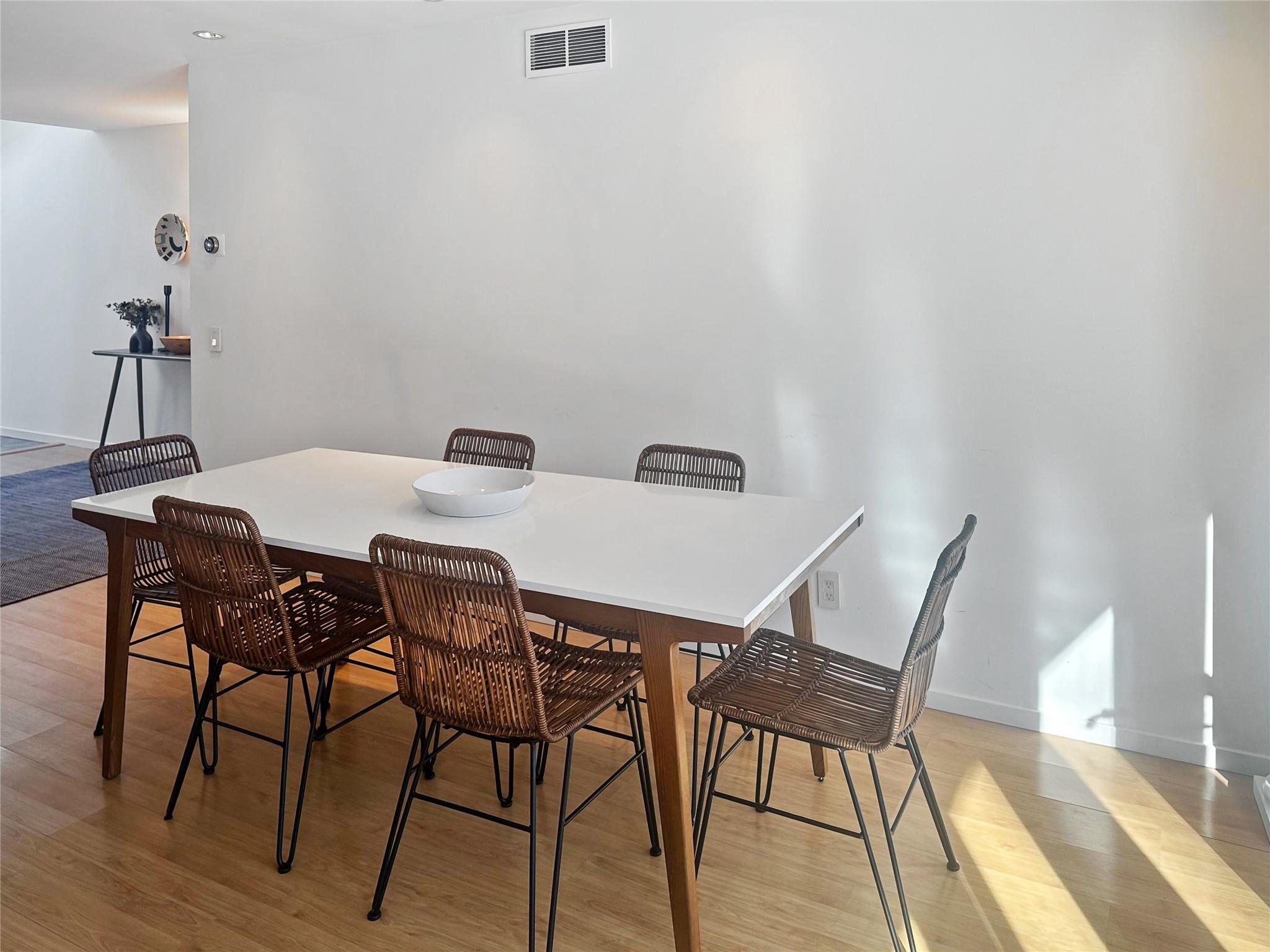 250 Pine Tree Court Cutchogue, NY 11935 - Photo 13 of 25 a view of a dining room with furniture and wooden floor