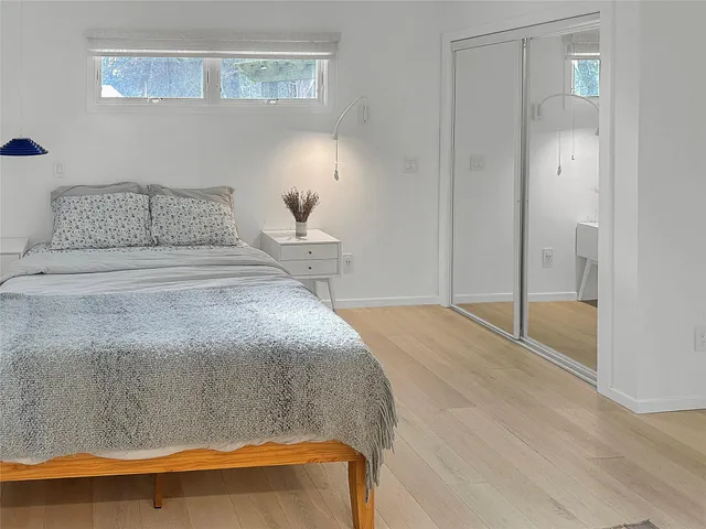a bedroom with a bed and with wooden floor