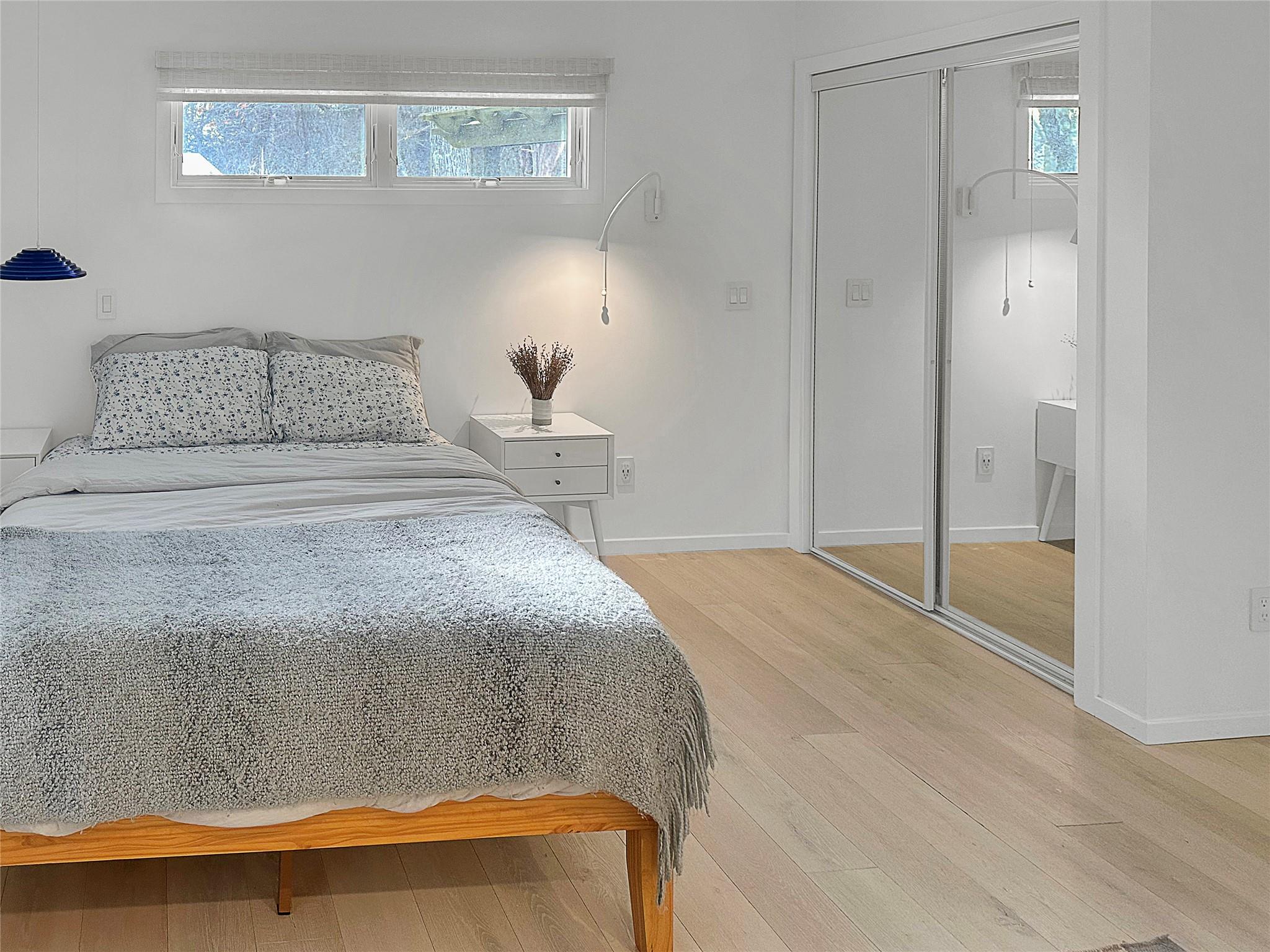 250 Pine Tree Court Cutchogue, NY 11935 - Photo 14 of 25 a bedroom with a bed and with wooden floor