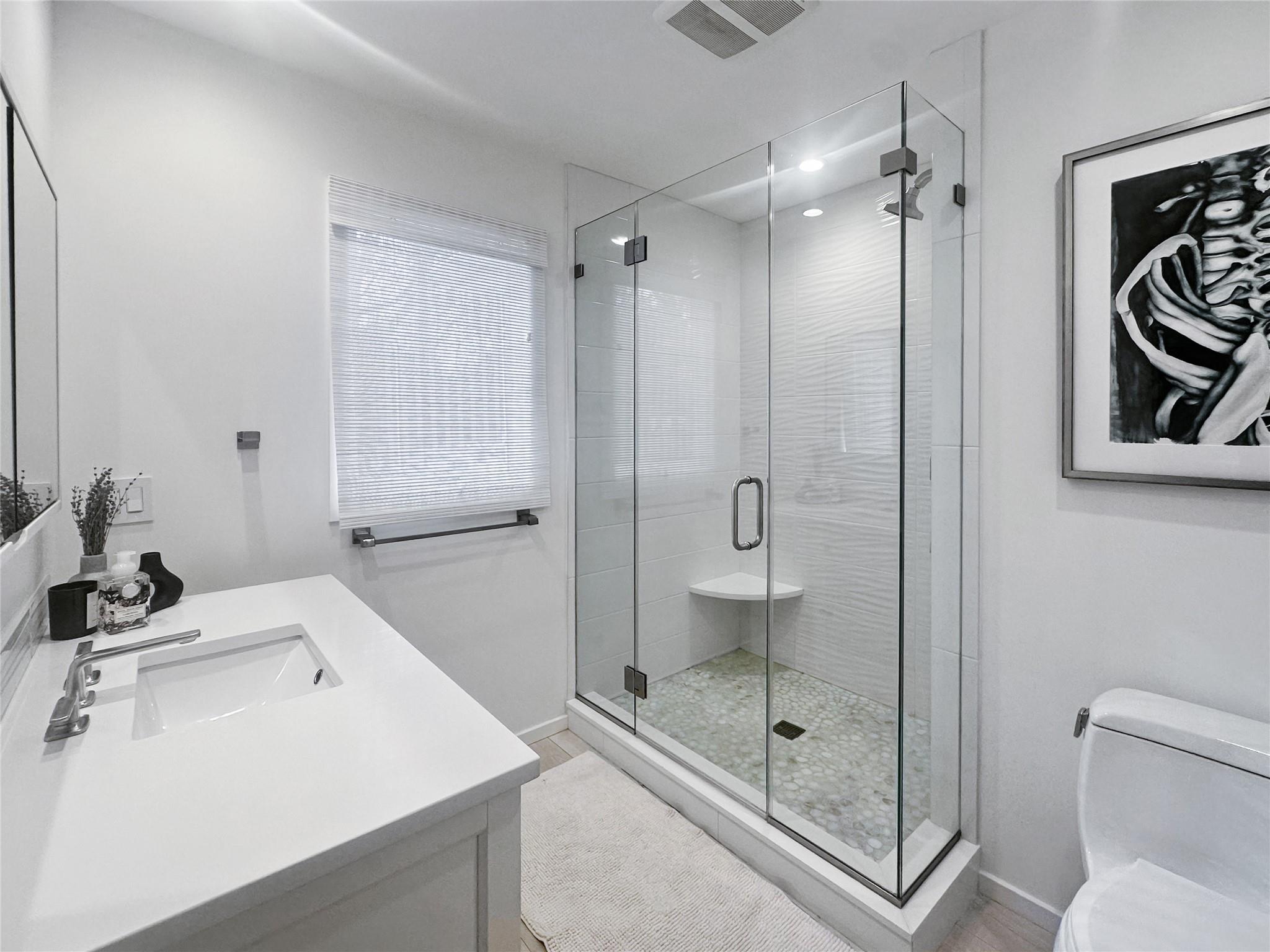 250 Pine Tree Court Cutchogue, NY 11935 - Photo 15 of 25 a bathroom with a shower sink mirror and toilet