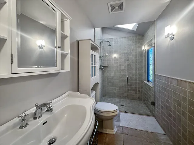 a bathroom with a sink toilet and shower