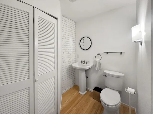 a bathroom with a toilet a sink and a window