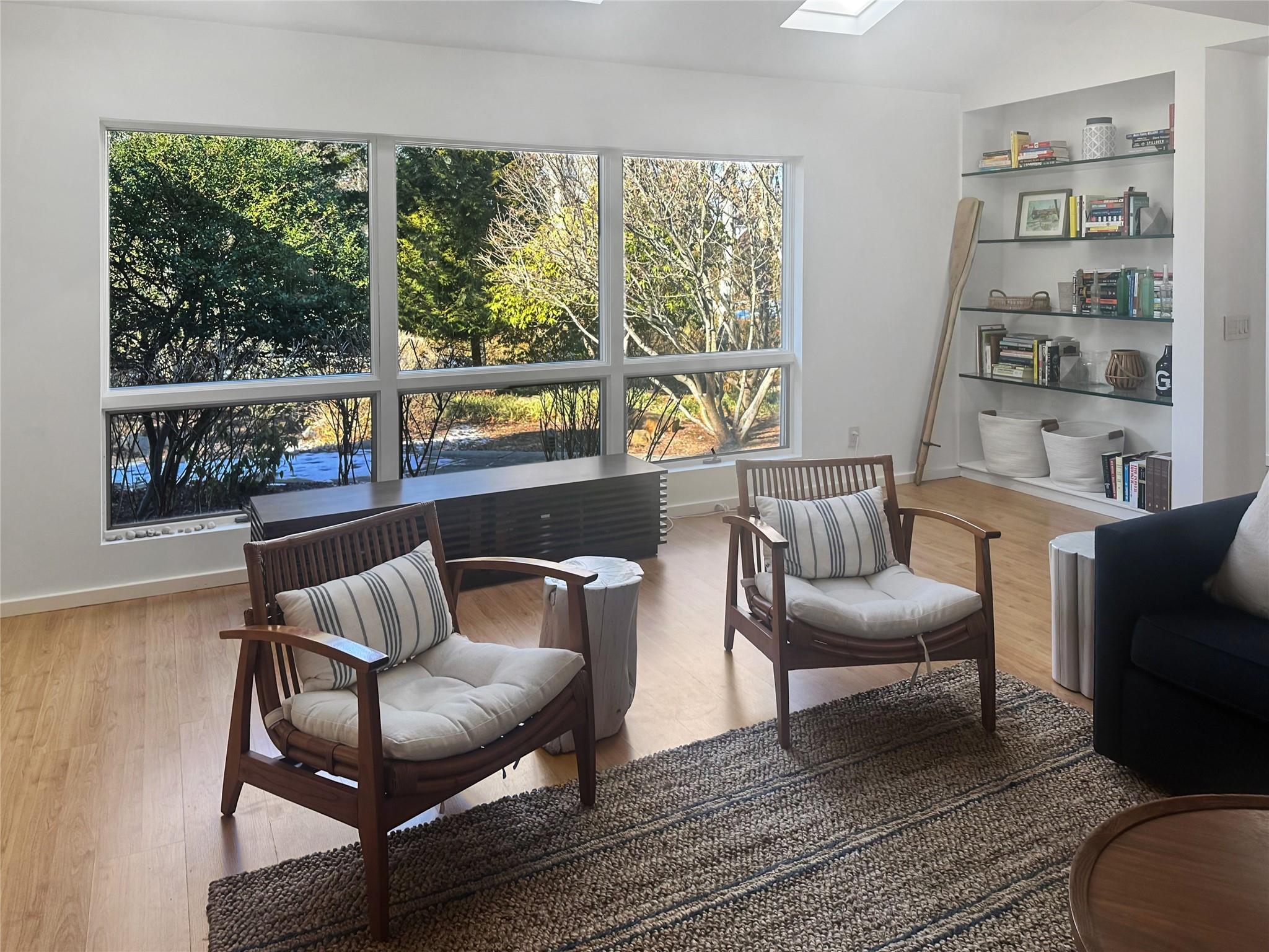 250 Pine Tree Court Cutchogue, NY 11935 - Photo 4 of 25 a living room with furniture and a floor to ceiling window