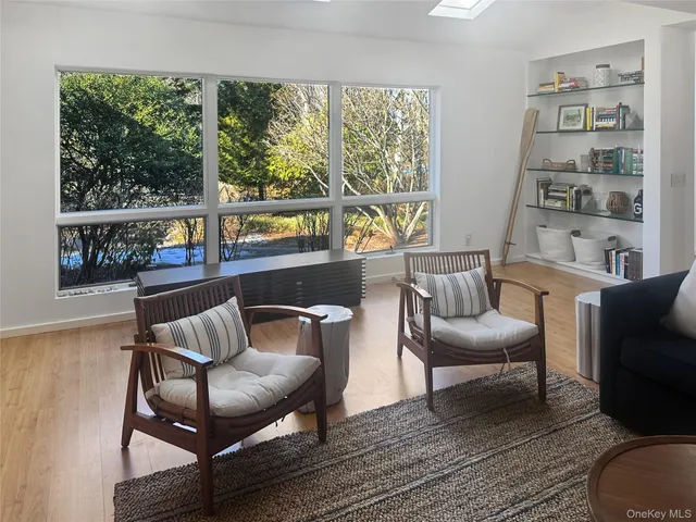 a living room with furniture and a floor to ceiling window