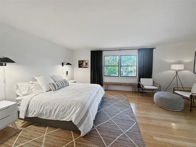 a bedroom with a bed couch and window