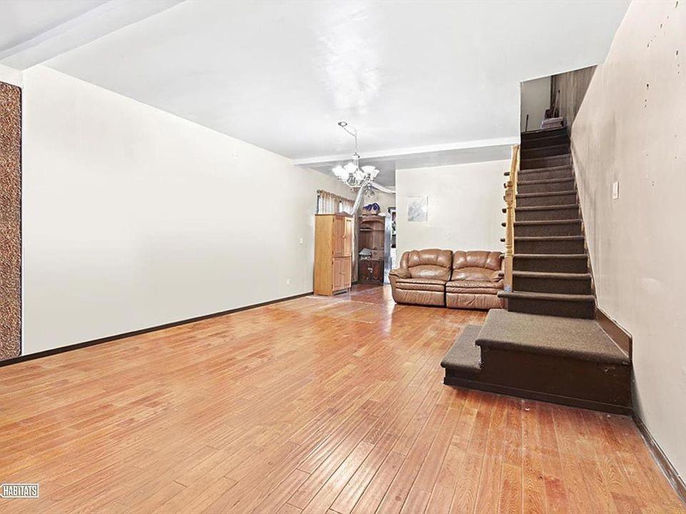 980 Lenox Road Brooklyn, NY 11212 - Photo 2 of 4 a view of a livingroom with wooden floor and stairs