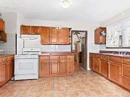 980 Lenox Road Brooklyn, NY 11212 - Photo 3 of 4 a kitchen with stainless steel appliances granite countertop a refrigerator and a stove top oven