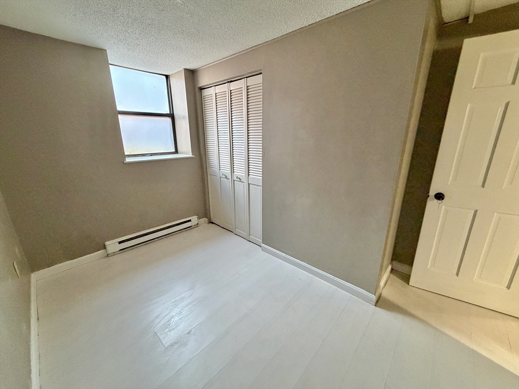 379 Meridian Street, Unit 101 Boston, MA 02128 - Photo 7 of 10 an empty room with windows