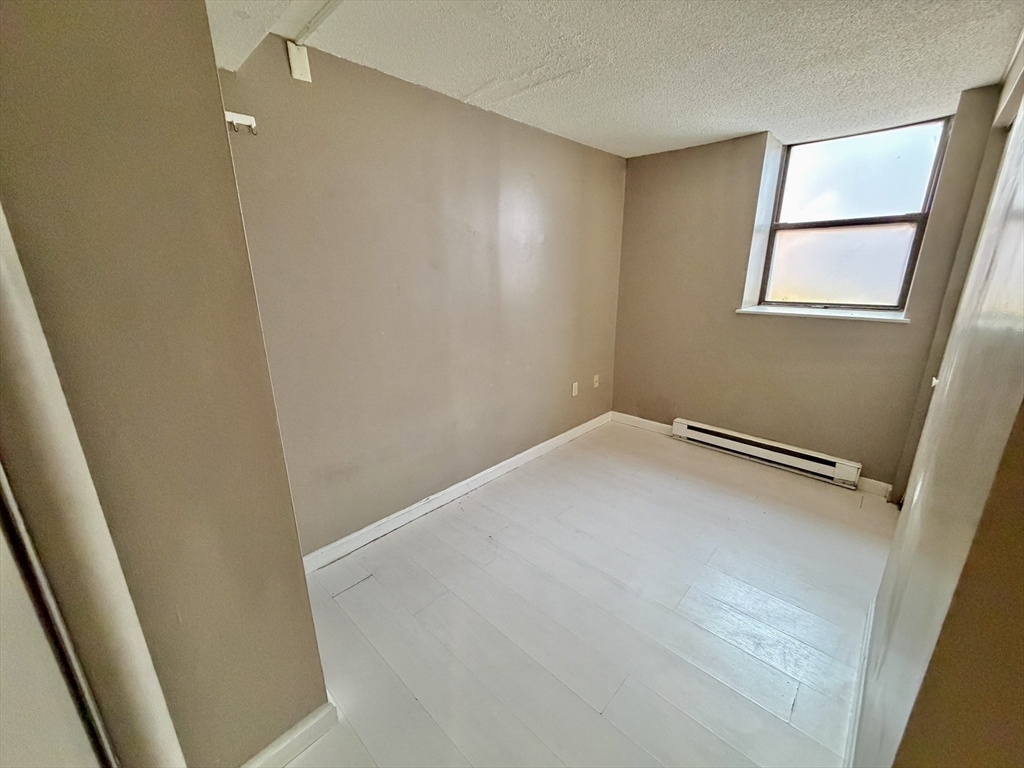 379 Meridian Street, Unit 101 Boston, MA 02128 - Photo 8 of 10 a view of a room with wooden floor and small space