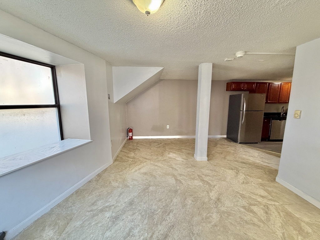 379 Meridian Street, Unit 101 Boston, MA 02128 - Photo 9 of 10 a view of a big room with closet and windows