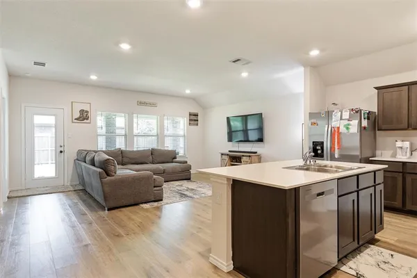 a view of a dining room with furniture and wooden floor