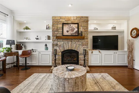 a living room with furniture a flat screen tv and a fireplace
