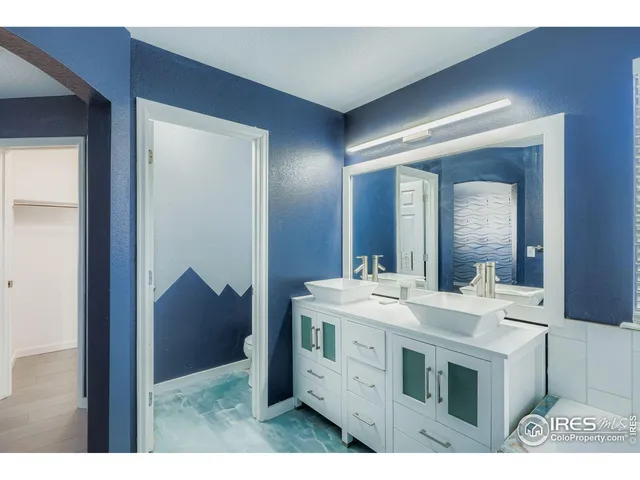 a bathroom with a sink a mirror and a vanity