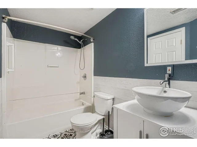 a bathroom with a sink toilet a mirror and shower