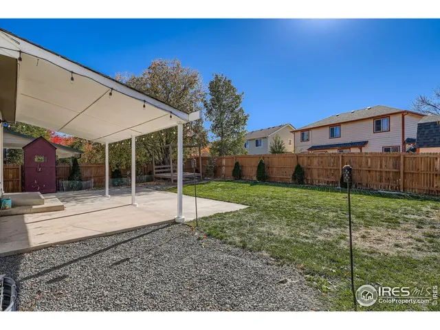a view of a house with backyard and porch