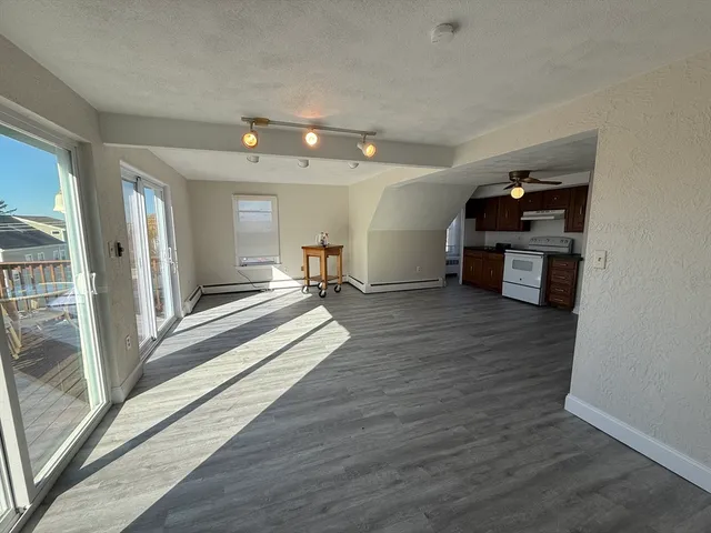 a view of a kitchen with a sink and wooden floor