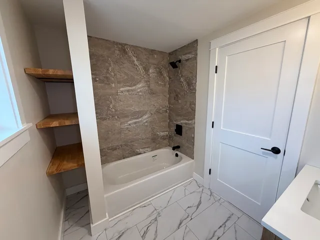 a bathroom with a bathtub and a shower