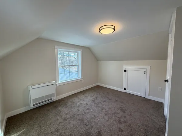 a view of an empty room and a window