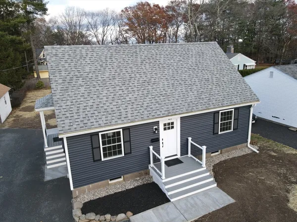 a aerial view of a house with a yard and stairs