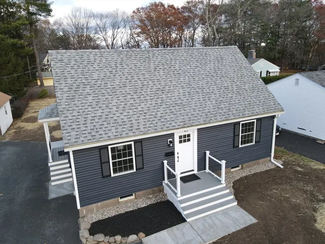 a aerial view of a house with a yard and stairs