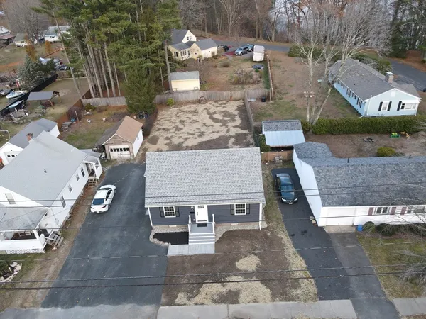 an aerial view of a house with garden space and street view