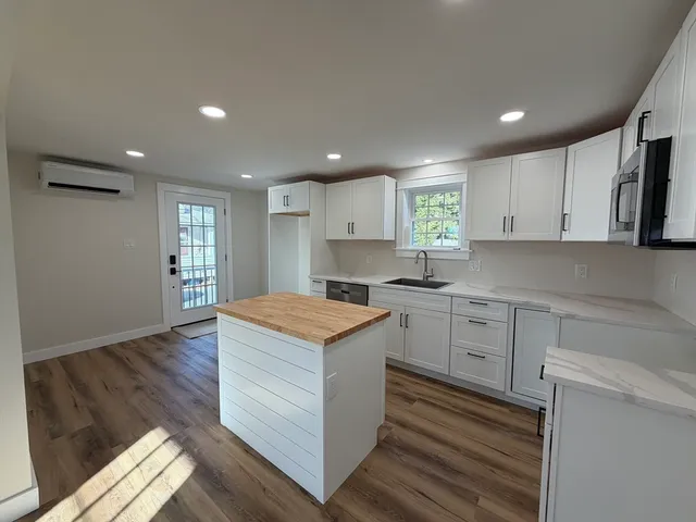 a kitchen with a stove a sink and a refrigerator