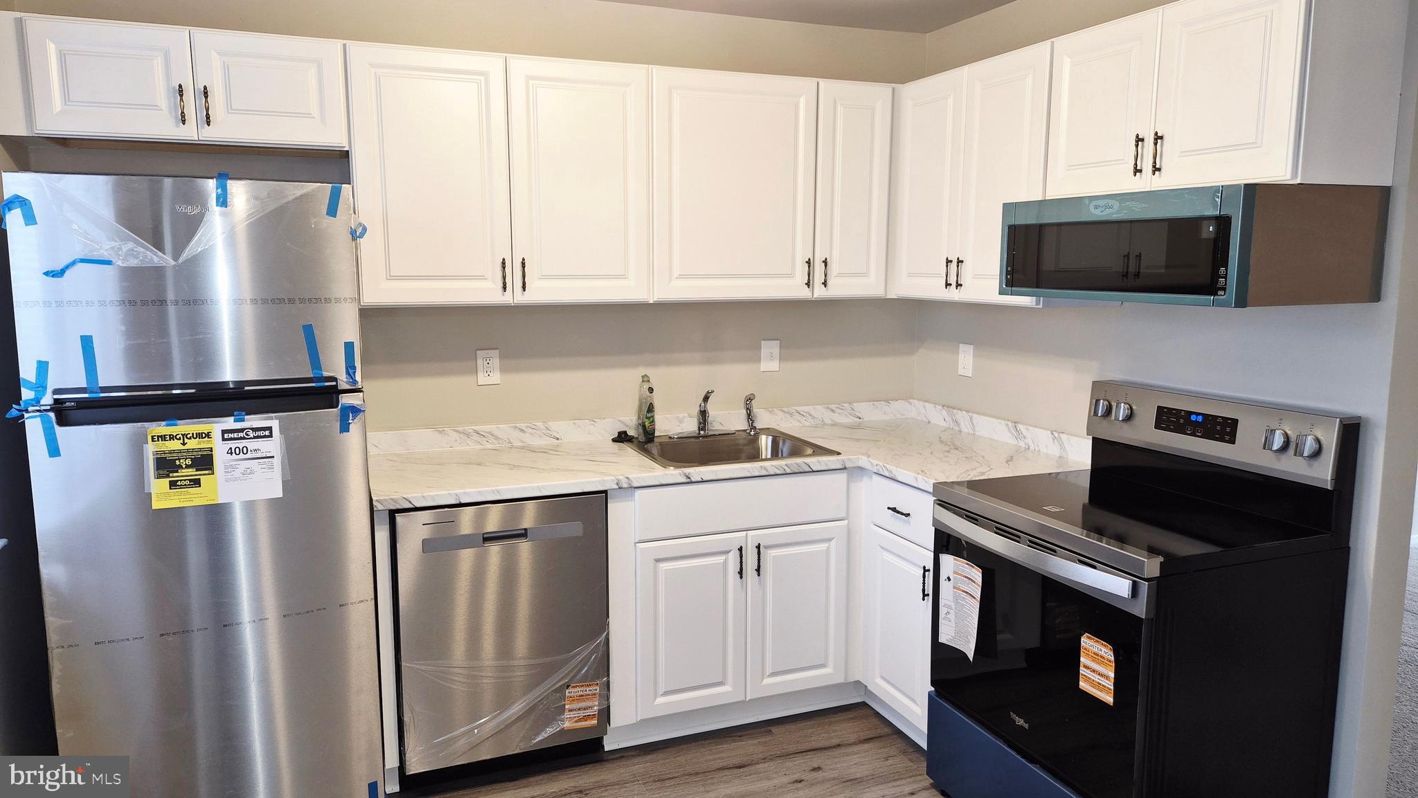 1041 Cedar Ridge Court Annapolis, MD 21403 - Photo 14 of 37 a kitchen with stainless steel appliances a stove microwave and sink