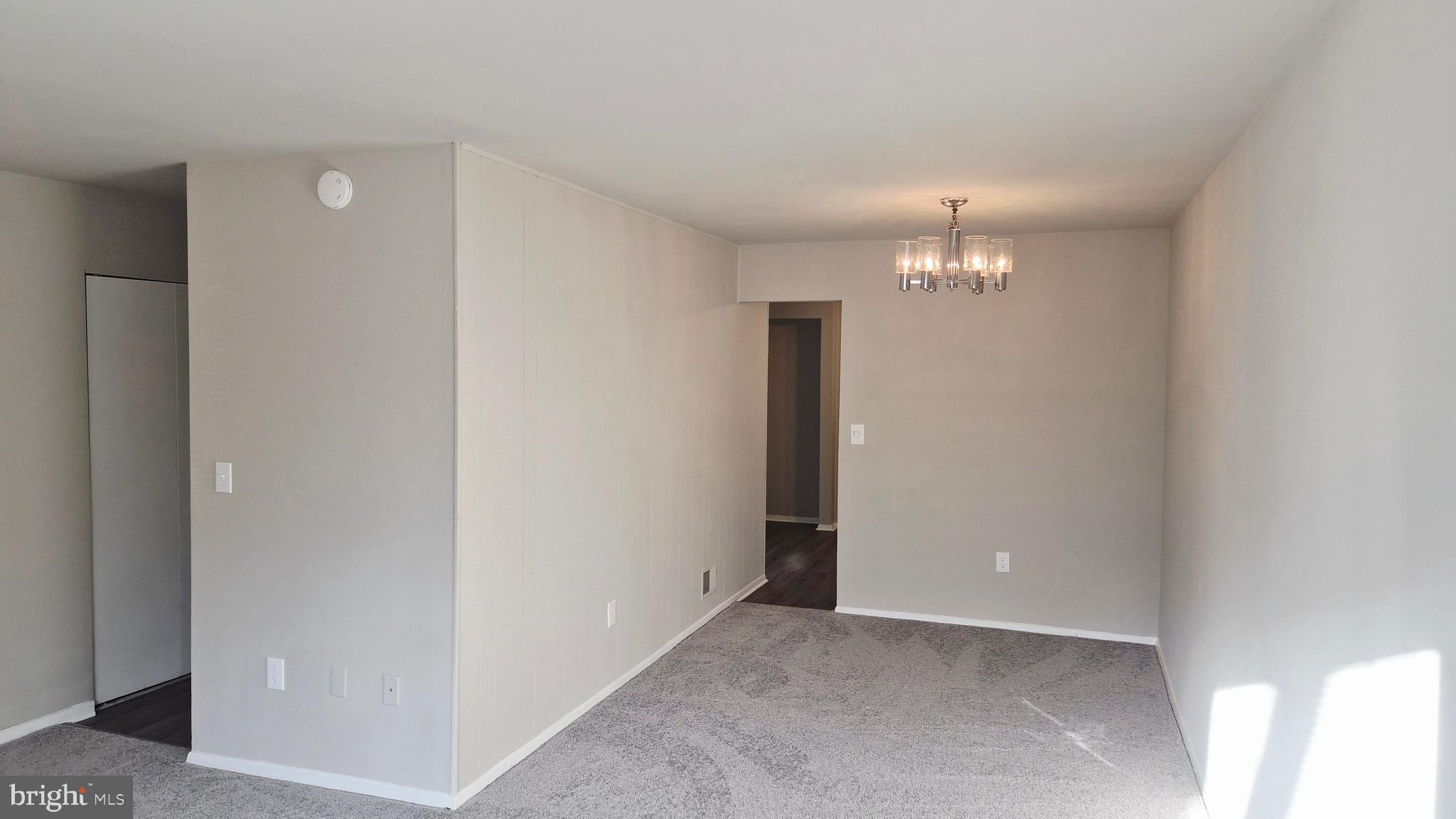 1041 Cedar Ridge Court Annapolis, MD 21403 - Photo 20 of 37 an empty room with a chandelier fan and closet area