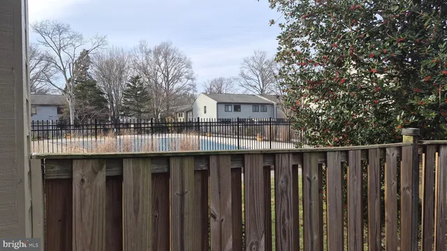 a view of wooden house with a wooden fence