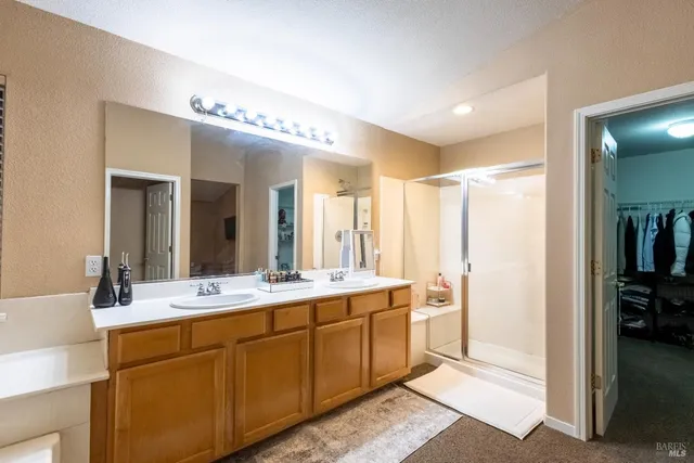 a spacious bathroom with a double vanity sink mirror and
