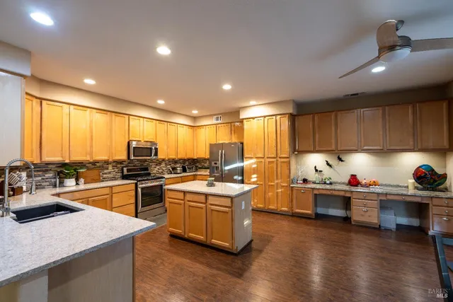 a kitchen with lots of counter top space and appliances