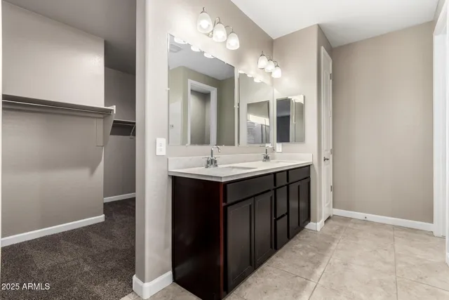 a bathroom with a sink vanity and a mirror