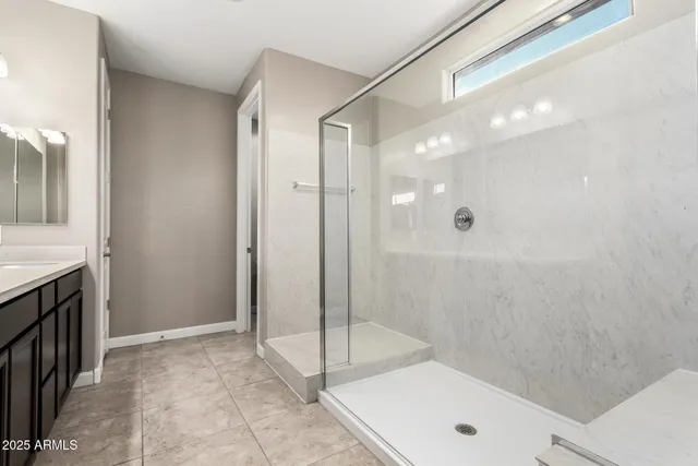 a bathroom with a shower and a sink