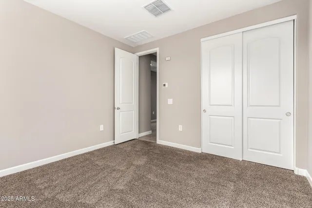 an empty room with closet area
