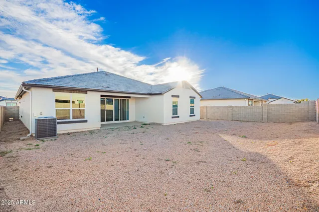 a view of a house with a backyard
