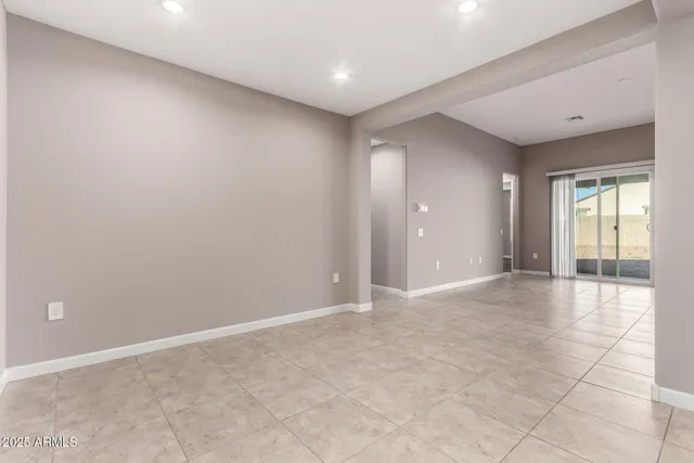 an empty room with windows and entrance