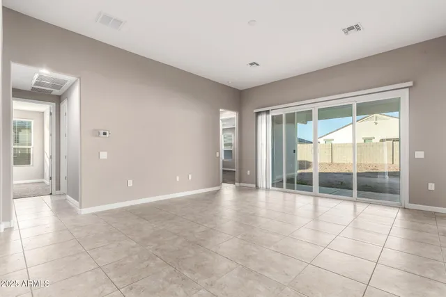 a view of an empty room with glass door