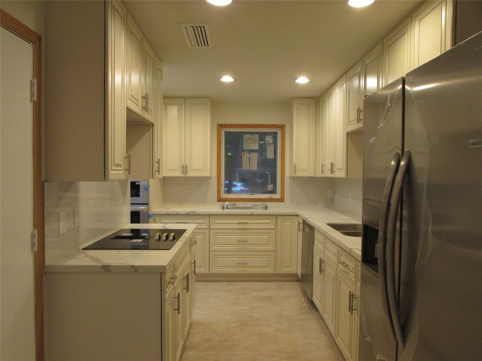 201 Vanderpool Lane, Unit 19 Houston, TX 77024 - Photo 8 of 23 a kitchen with cabinets and stainless steel appliances