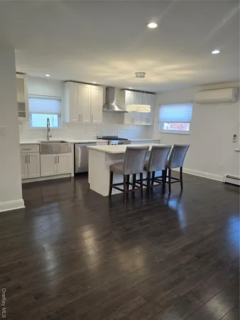 a large kitchen with a table and chairs
