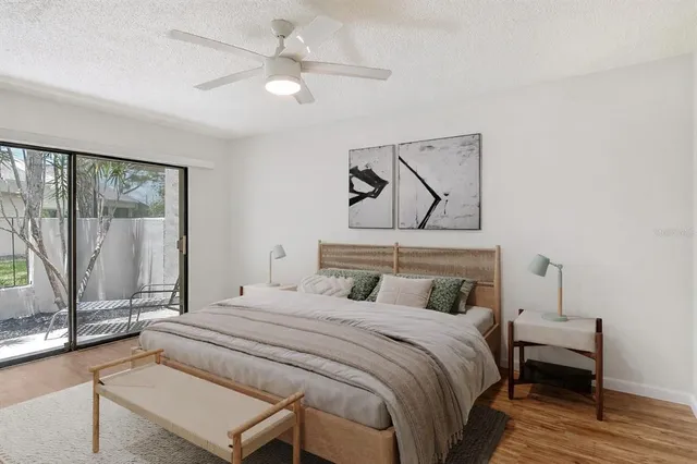 a spacious bedroom with a bed and a cabinets