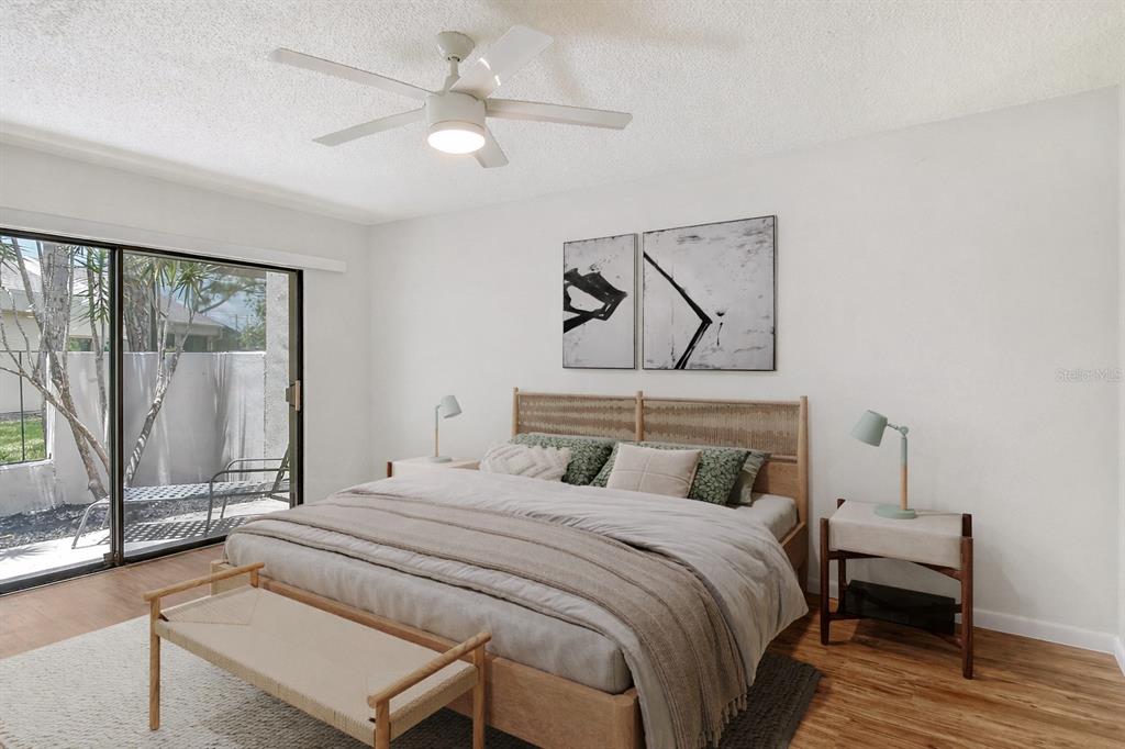 2517 Glebe Farm Close, Unit H2 Sarasota, FL 34235 - Photo 17 of 59 a bedroom with a bed and a chandelier