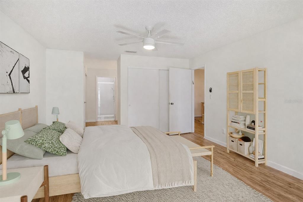 2517 Glebe Farm Close, Unit H2 Sarasota, FL 34235 - Photo 19 of 59 a spacious bedroom with a bed and a cabinets