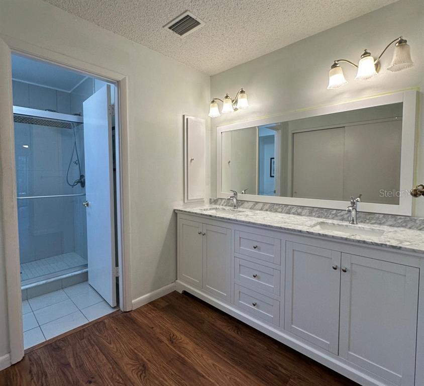 2517 Glebe Farm Close, Unit H2 Sarasota, FL 34235 - Photo 20 of 59 a bathroom with a double vanity sink and a mirror