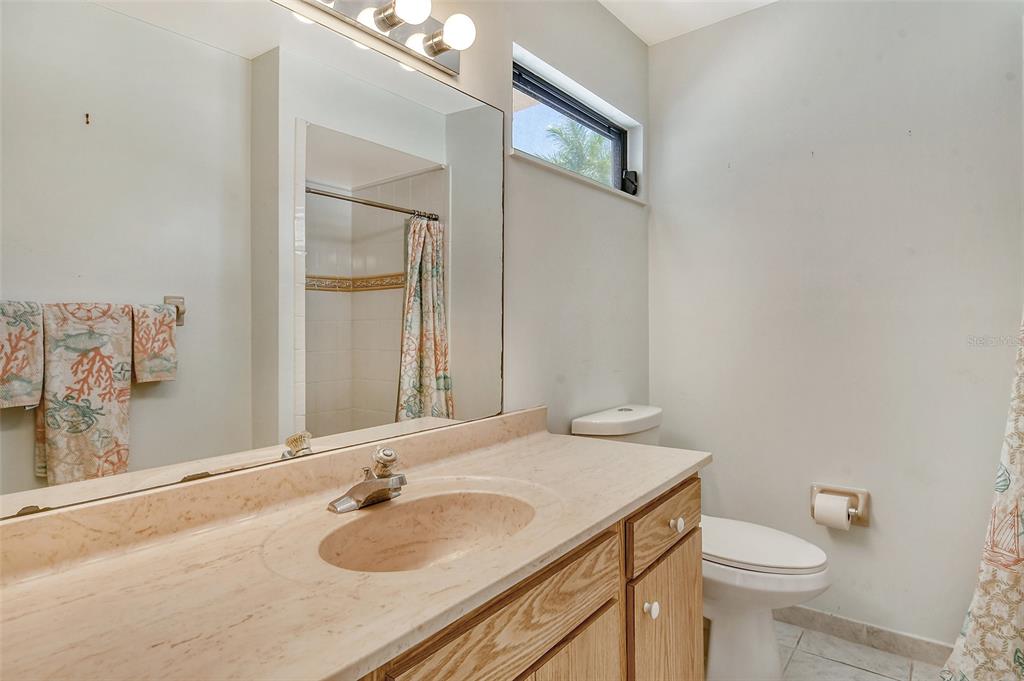 2517 Glebe Farm Close, Unit H2 Sarasota, FL 34235 - Photo 23 of 59 a bathroom with a sink and a toilet