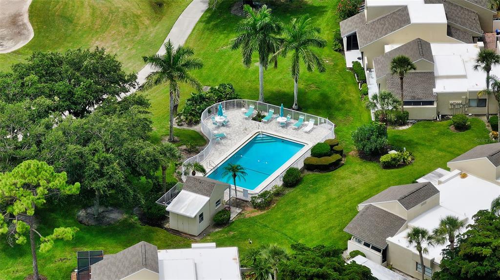 2517 Glebe Farm Close, Unit H2 Sarasota, FL 34235 - Photo 35 of 59 an aerial view of a house with a garden and trees